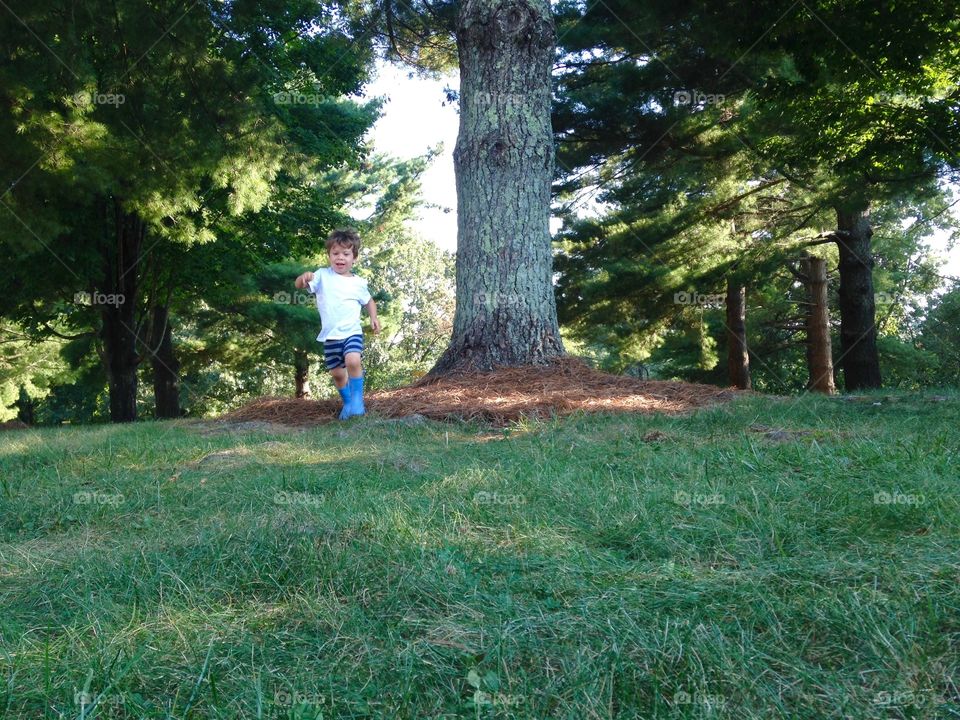 Boy playing outside in the summertime. 