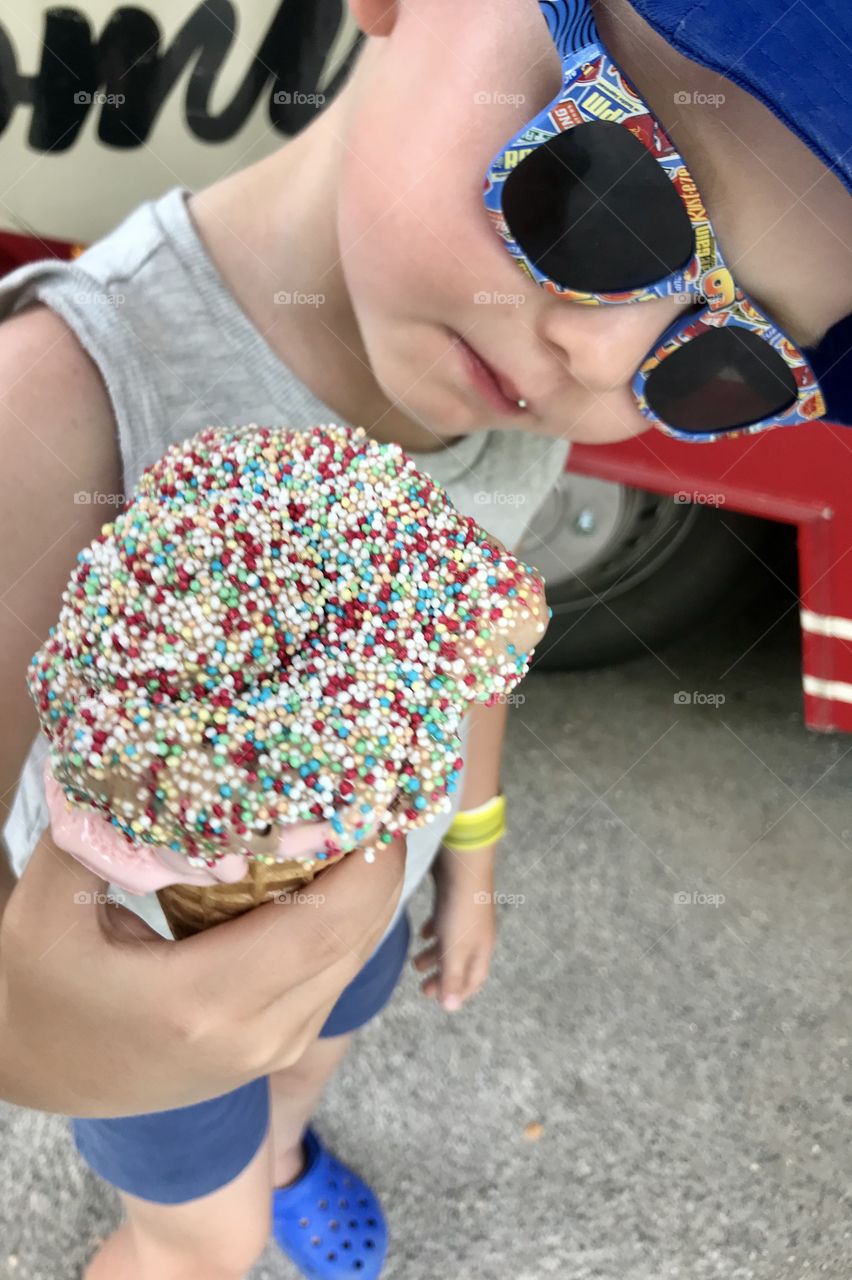 Little boy eats ice cream on a summer day
