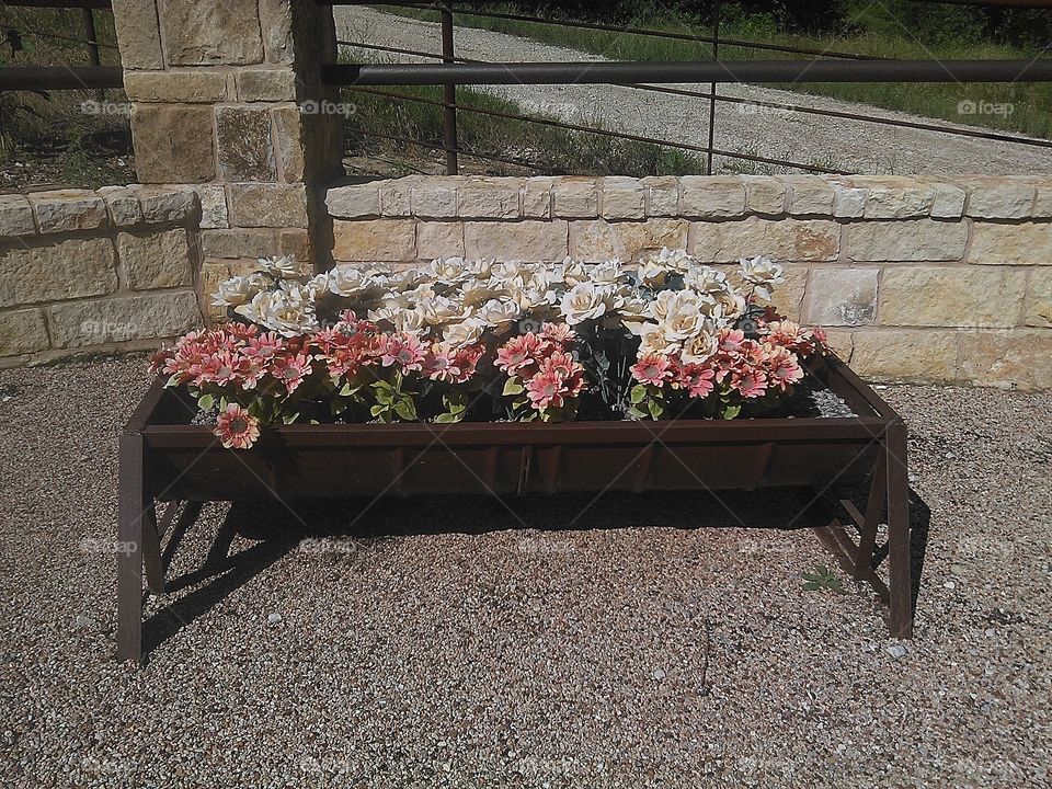 barrel flowers. this barrel made into a flower pot in front of the rock n ranch
