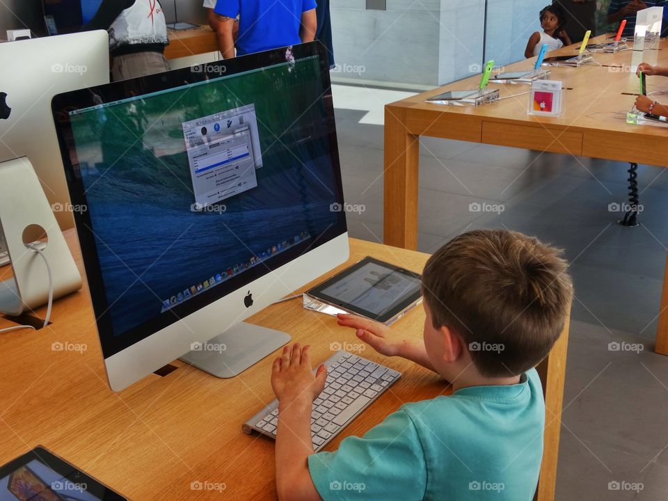 Desk From Above. Young Child Using A Computer On A Desk
