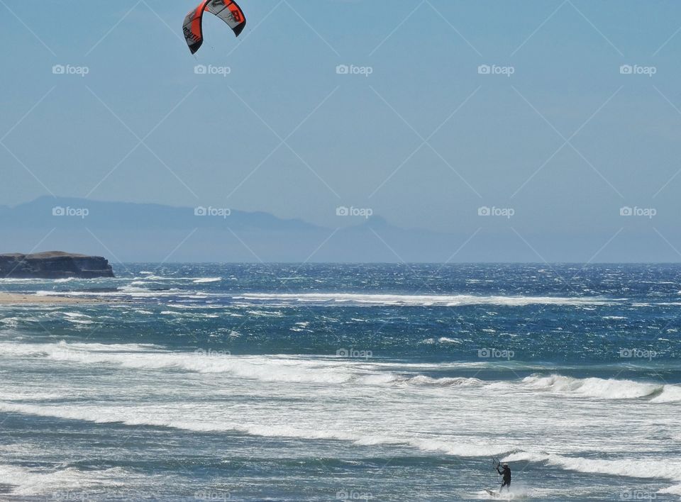 Windsurfing In California. Colorful Windsurfer Off The Coast Of Big Sur In California
