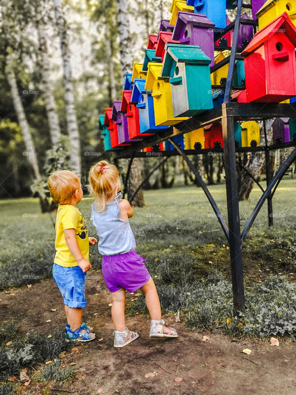 children near colored birdhouses