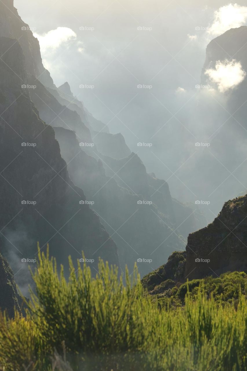 Landscape of mountains with clouds on top at sunset