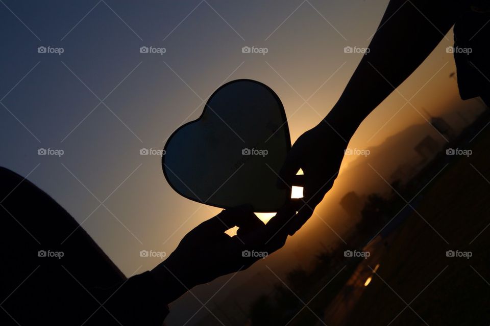 Couple holding heart in their hands