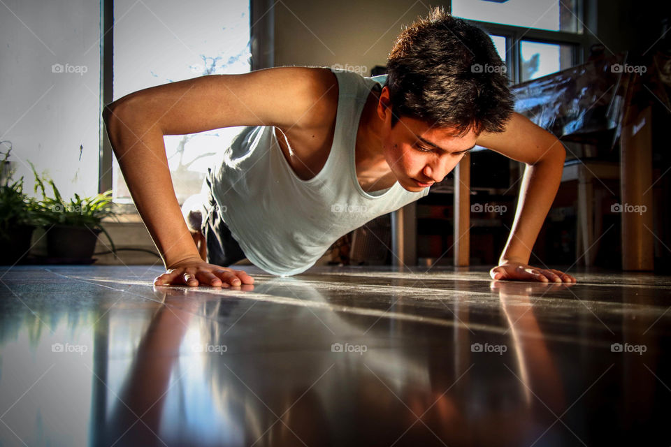 Teen boy is doing pushups