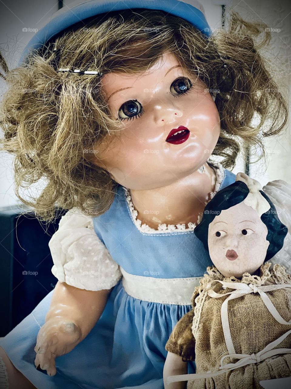 Vintage mission. Antique shop. Closeup of old dolls, one with a porcelain face. 