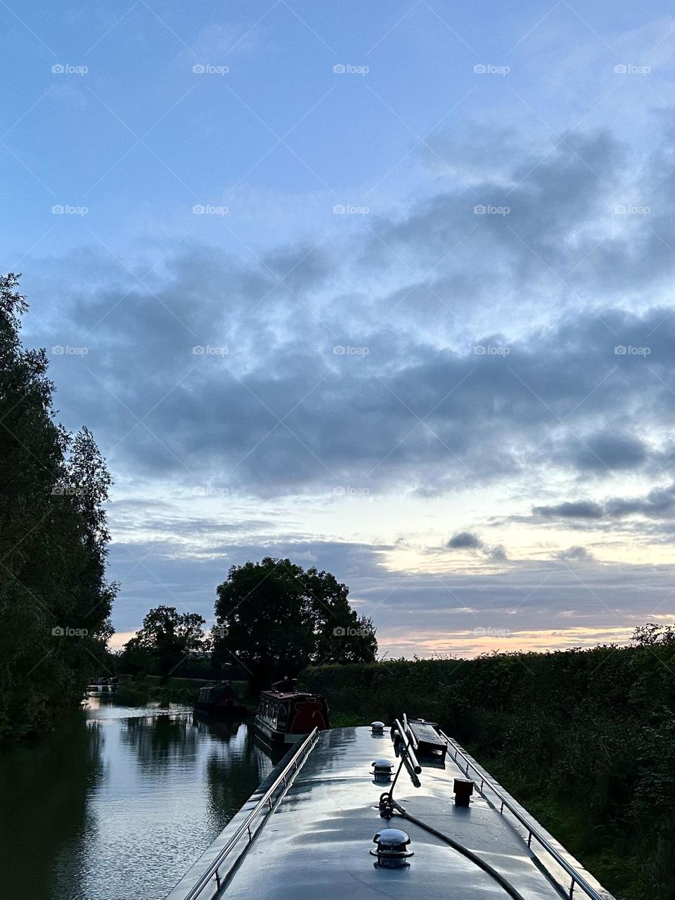 Gorgeous sunset sky near Flecknoe on Oxford canal narrowboat cruise late summer evening holiday vacation trees water sky reflection clouds horizon