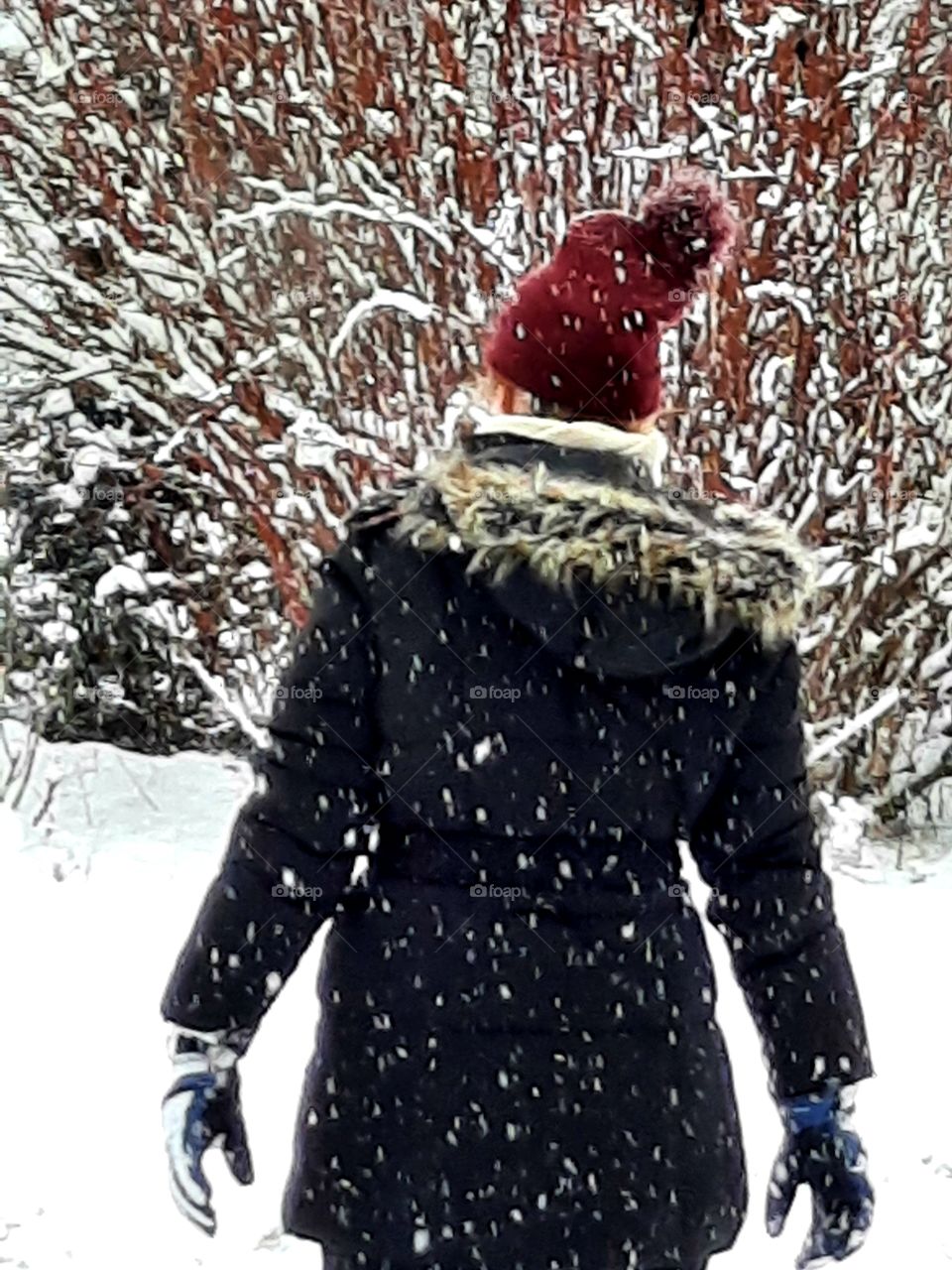 snow storm and a young woman in the garden