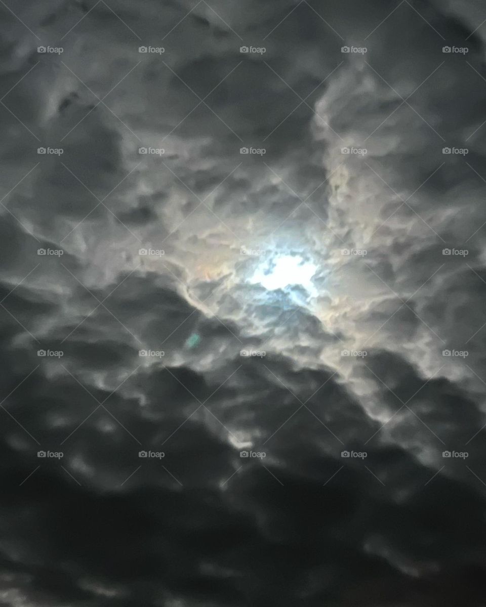 Blue moon breaking through clouds