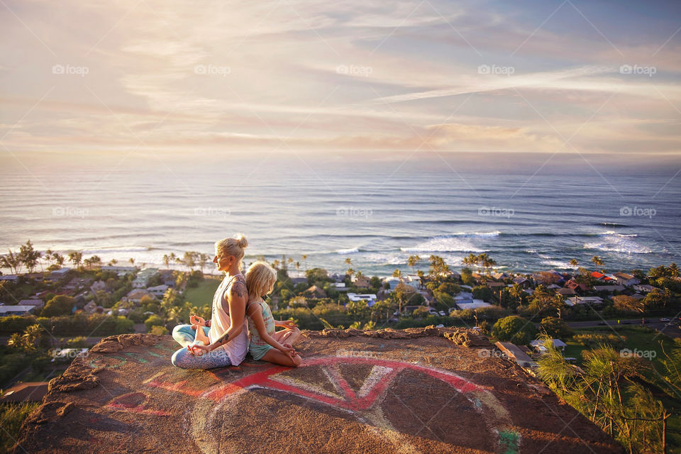 Mom and daughter peaceful yoga pose 