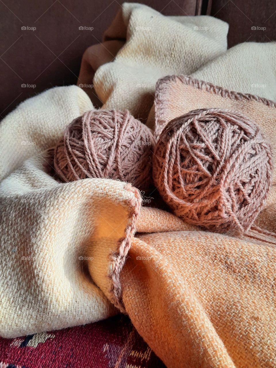 a pair of wool balls on wool blanket