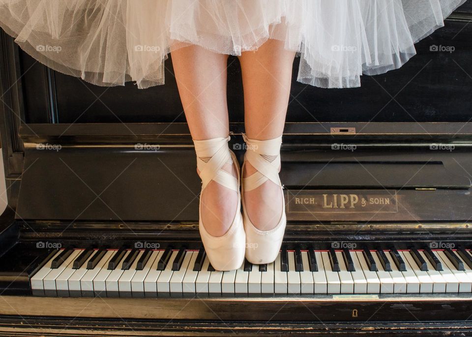 Ballerina Standing on A Piano