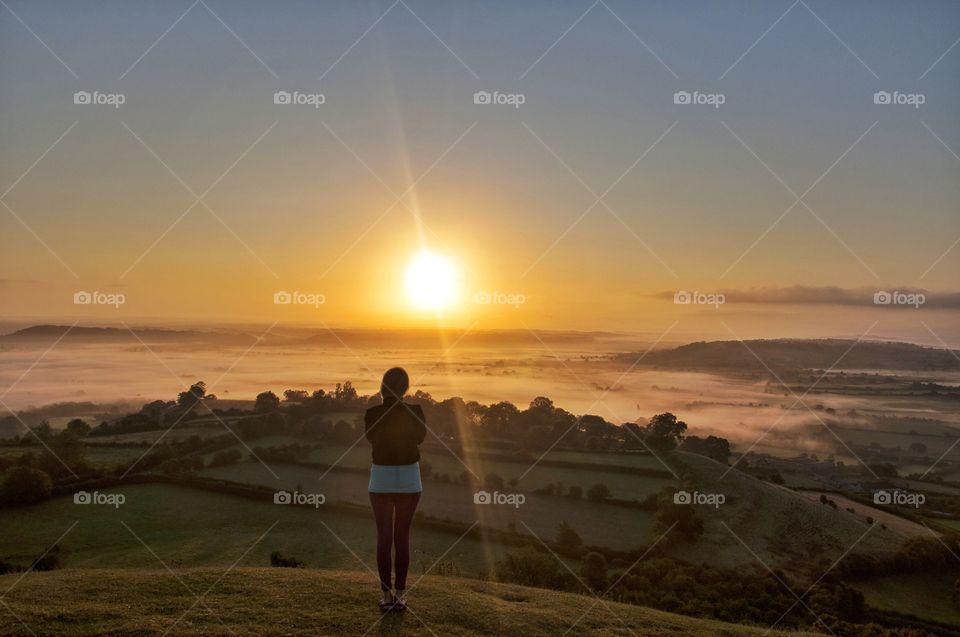 watching sunrise from glastonbury hill in england