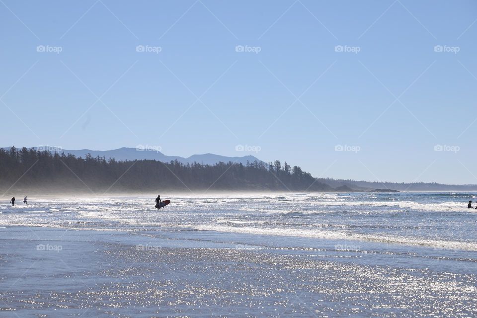 Surfer heading in the ocean 