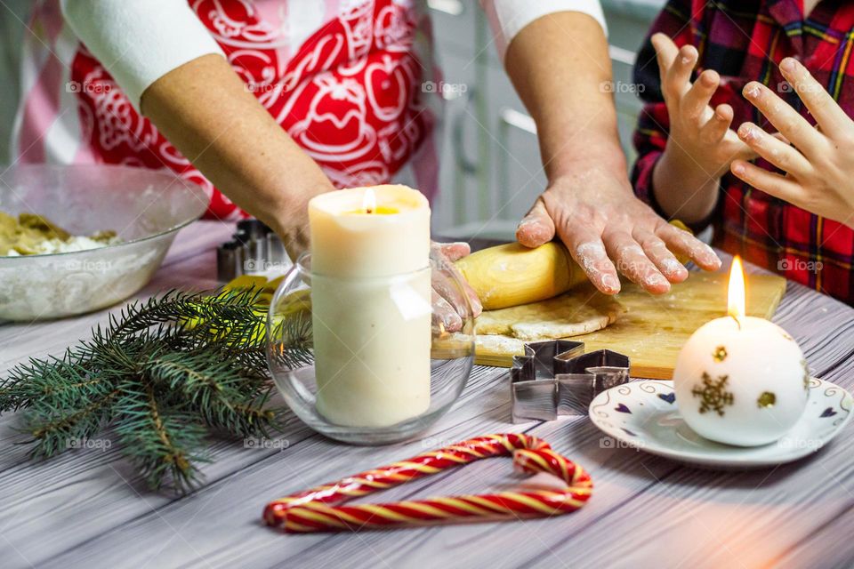 hands in the frame, the child and Mom are preparing cookies at home in the kitchen, fun