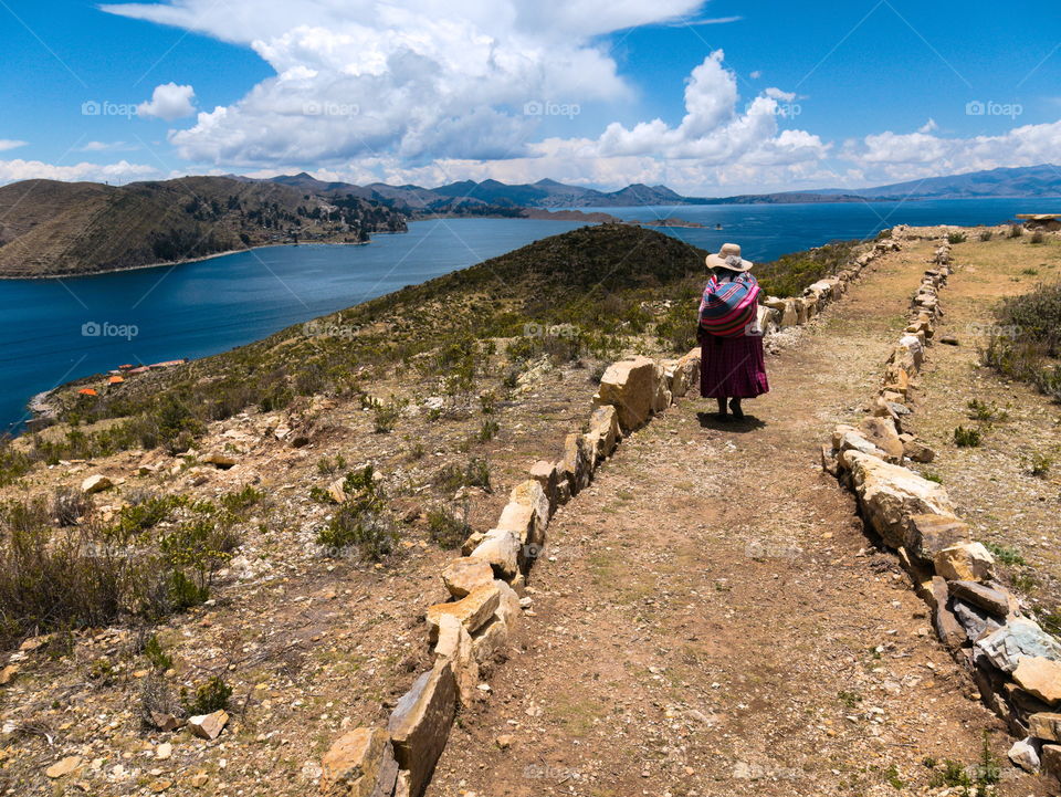 Local woman walking a beautiful island in Bolivia