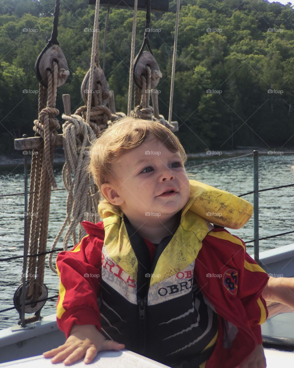 Cute boy standing in boat