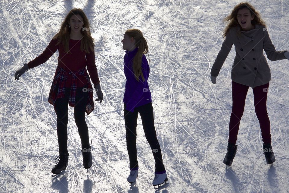 Happy girls on ice rink