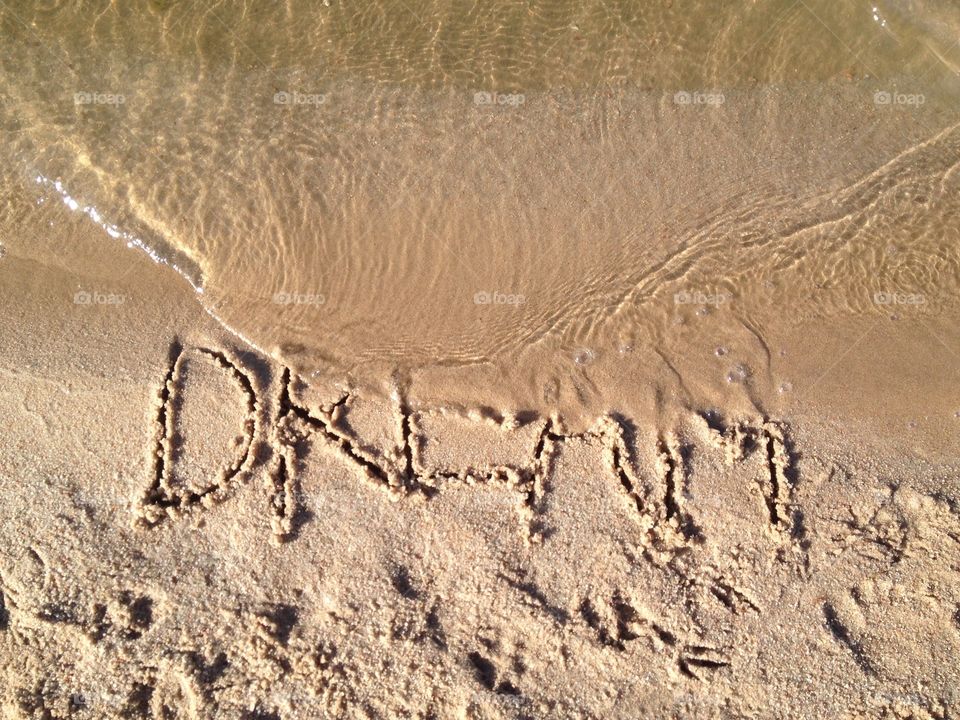 Dream. Word written in sand