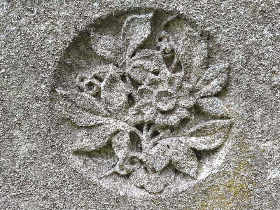 walking in an old graveyard can be a beautiful experience. Times gone by all with a story. This one told with an old grey stone and a floral engraving