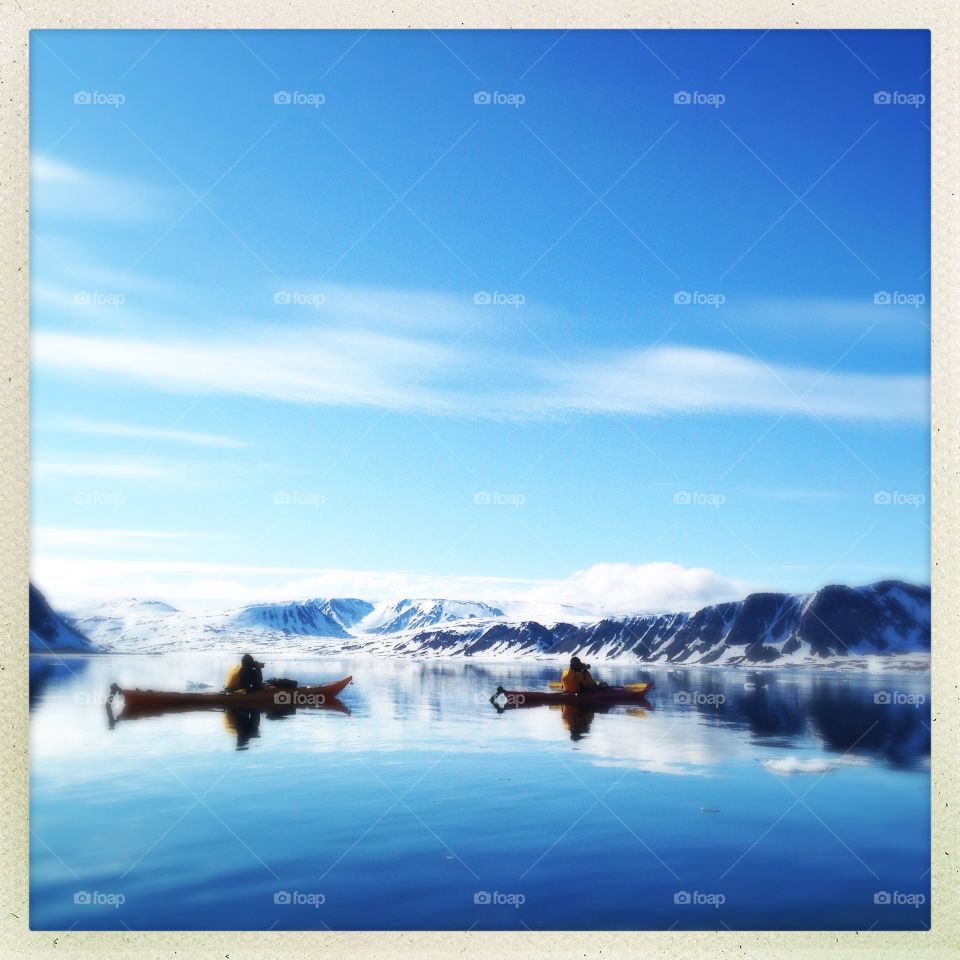 Kayaking in the arctic ice of Svalbard. 