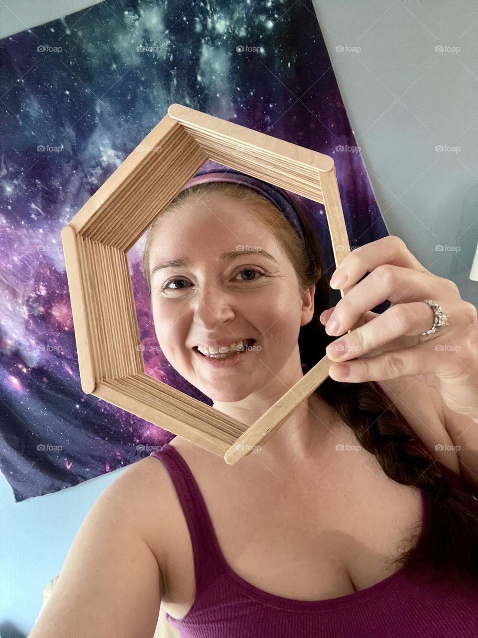 Young woman holding a popsicle stick craft shelf