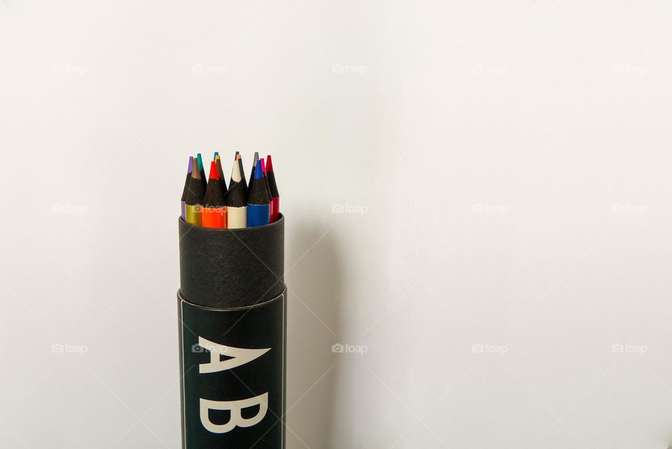 Colored design crayons in a black case.