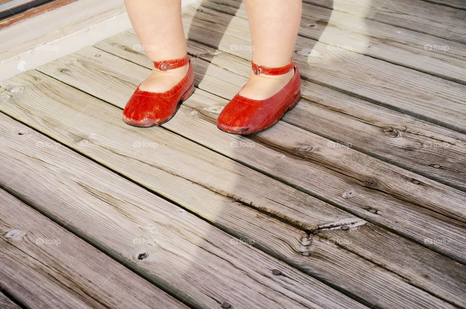 Girl wearing red shoe