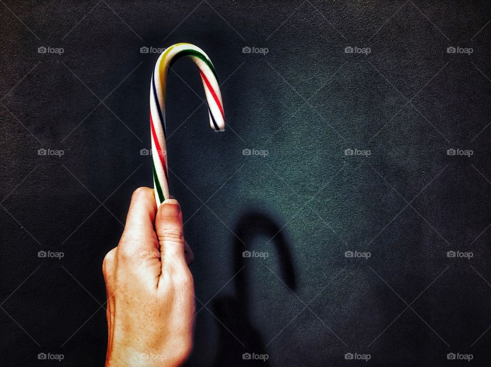Bright candy cane off a dark surface 