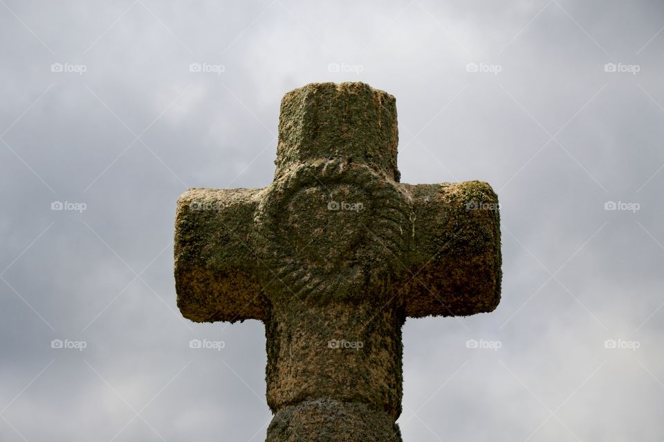 stone cross on the background of blue sky