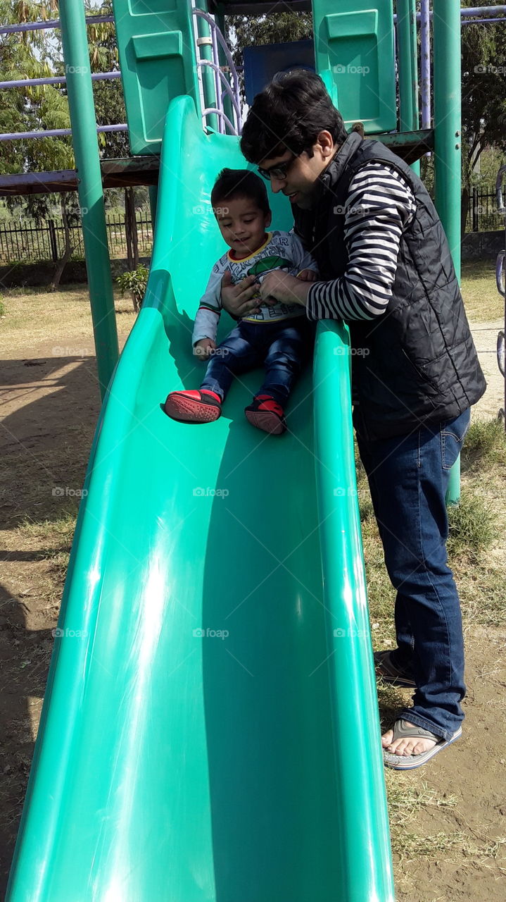 Little kid enjoying the slide