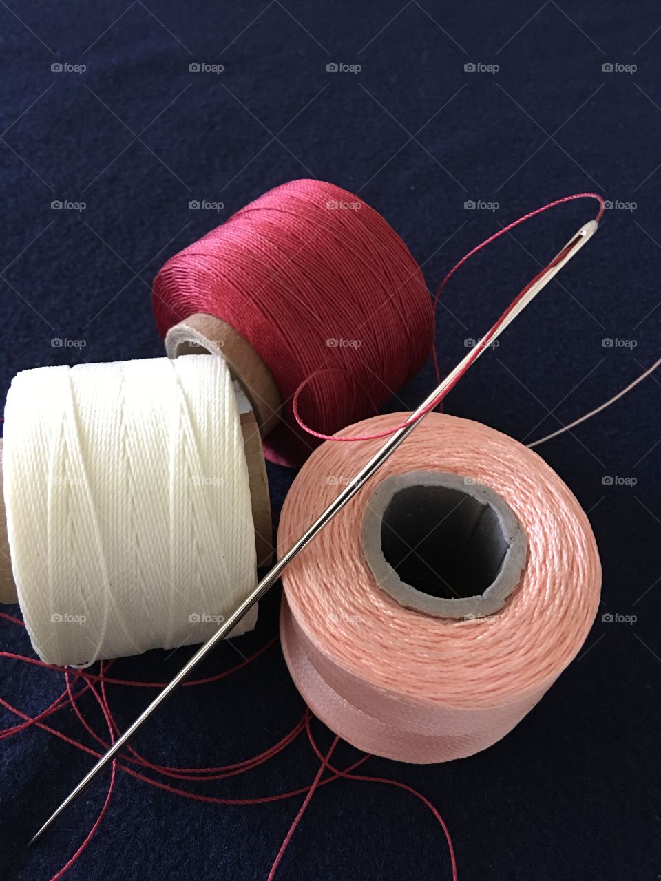 Red white and pink upholstery thread 