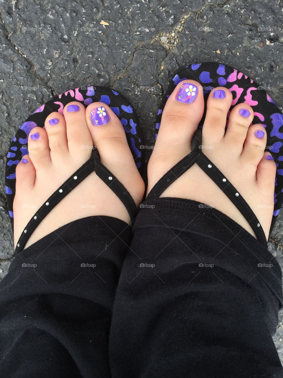 Manicured toes wearing flip flops 