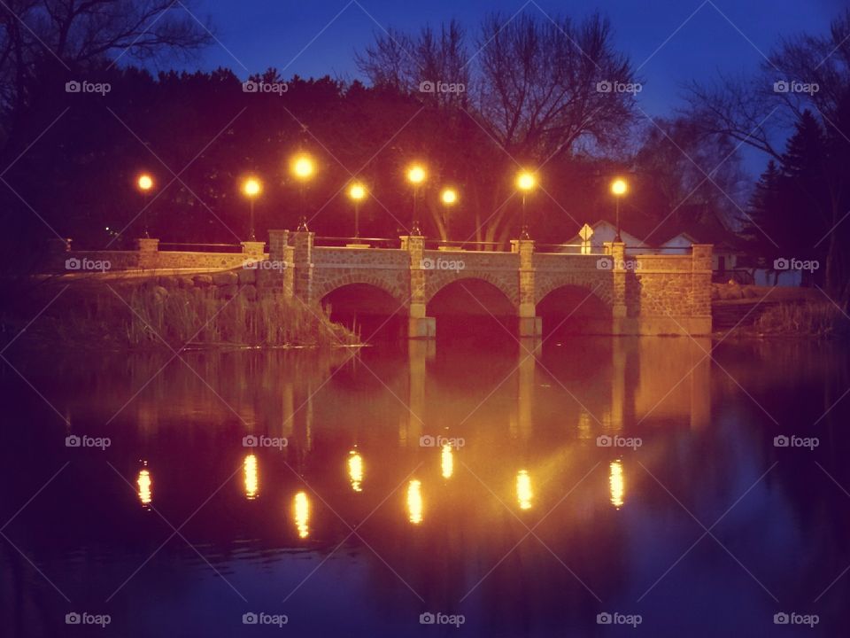 Hudson street bridge at night with water reflection on calm night antigo Wisconsin