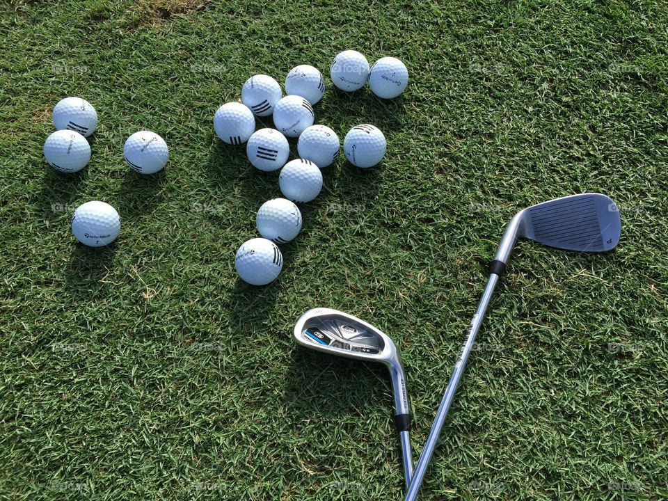 Golf. Golf clubs and balls on the grass