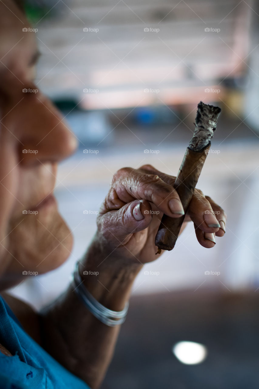 Old woman smoking Cuban Cigar