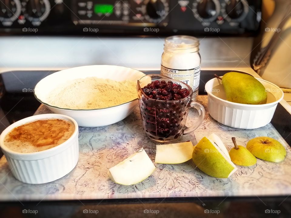 the ingredients for an old fashioned vegan blueberry pear cobbler : coconut oil almond milk vanilla whole wheat flour sugar salt baking powder cinnamon fresh pears chopped and frozen wild blueberries