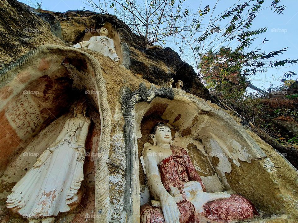 Ancient Buddha carvings in the rock a Irrawady River bank