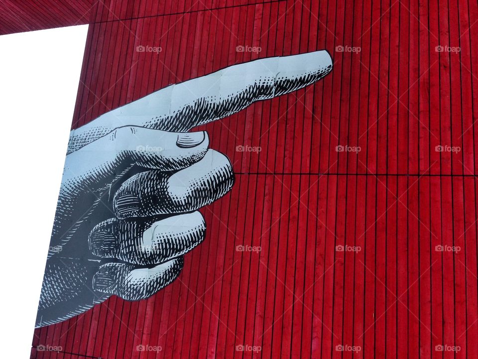 Pointing finger. Pointing finger on red background