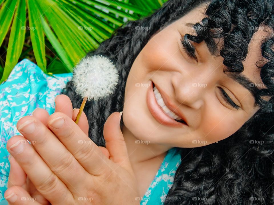 Women History month, woman looking at a dandelion 