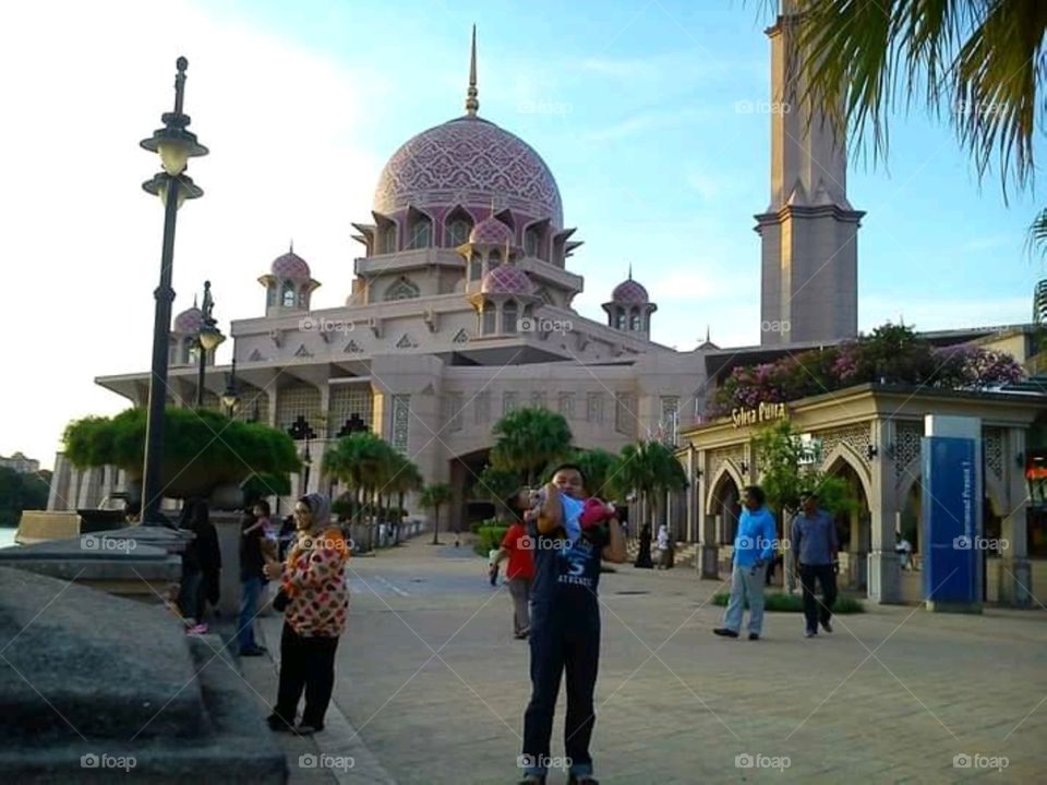 Putrajaya Mosque, Malaysia - A model and his son act for the camera in front of Putrajaya Mosque