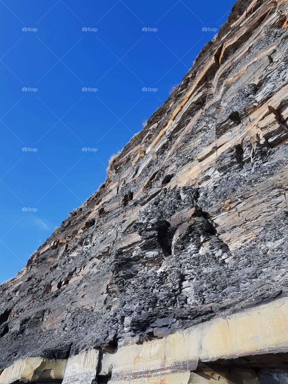 An English coastal cliff face with blue skies.