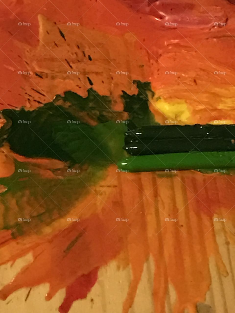 Melting crayons with a hair dryer splatters the colors