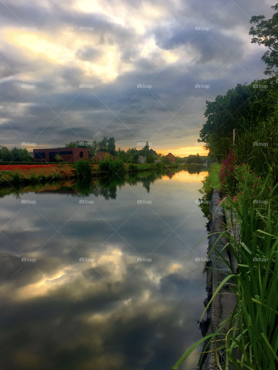 The last of the sun, a dramatic sunset reflected in the water of the river