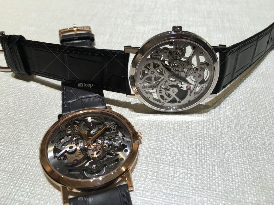 Two wristwatches on table