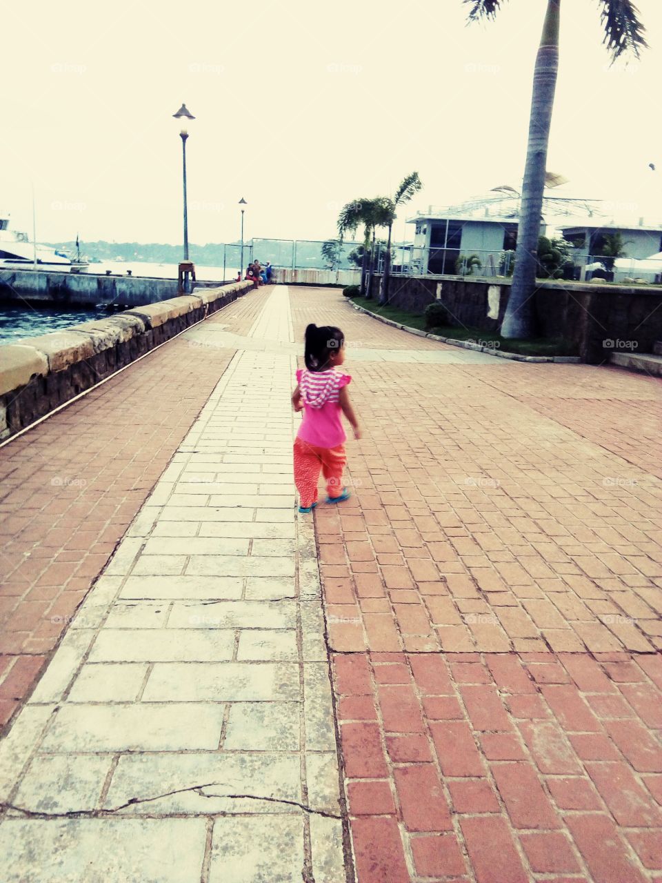 A little kiddo taking a walk at the boardwalk
