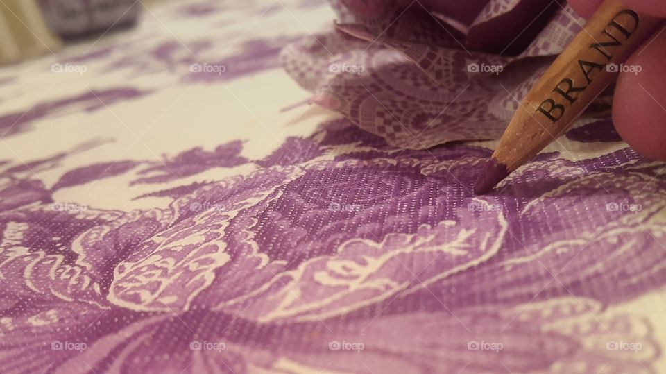 purple flower on table cloth with colored pencil and purple background