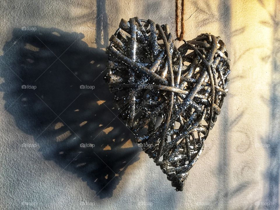 Heart shaped ornament hanging on wall