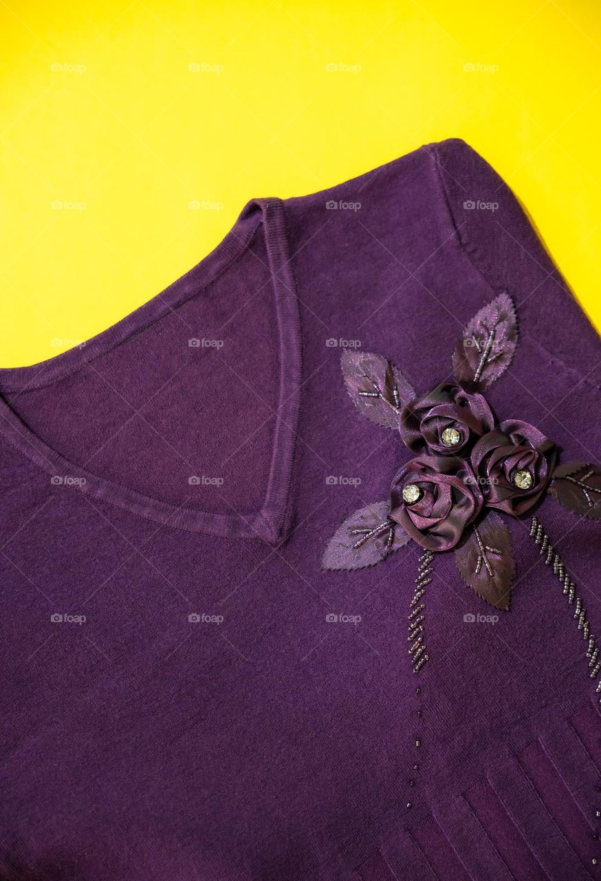 A V-neck women's top on a yellow background