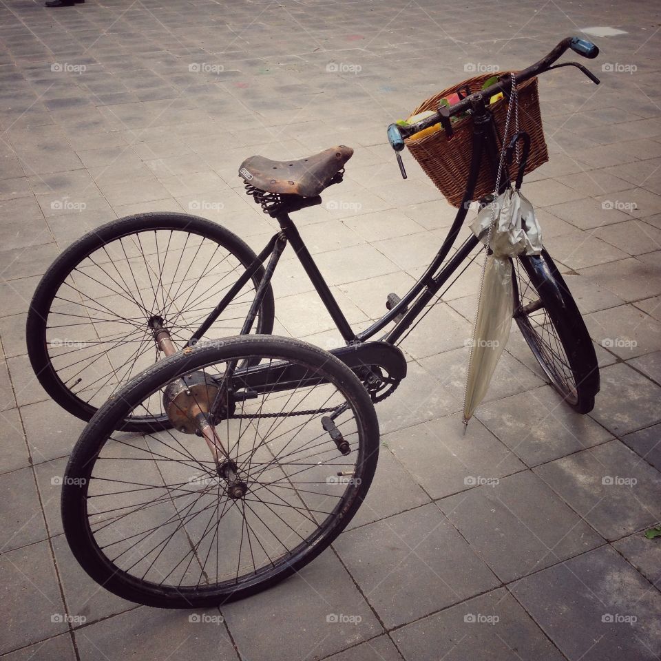 Vintage three wheel bicycle on a gray floor in Moscow, Russia